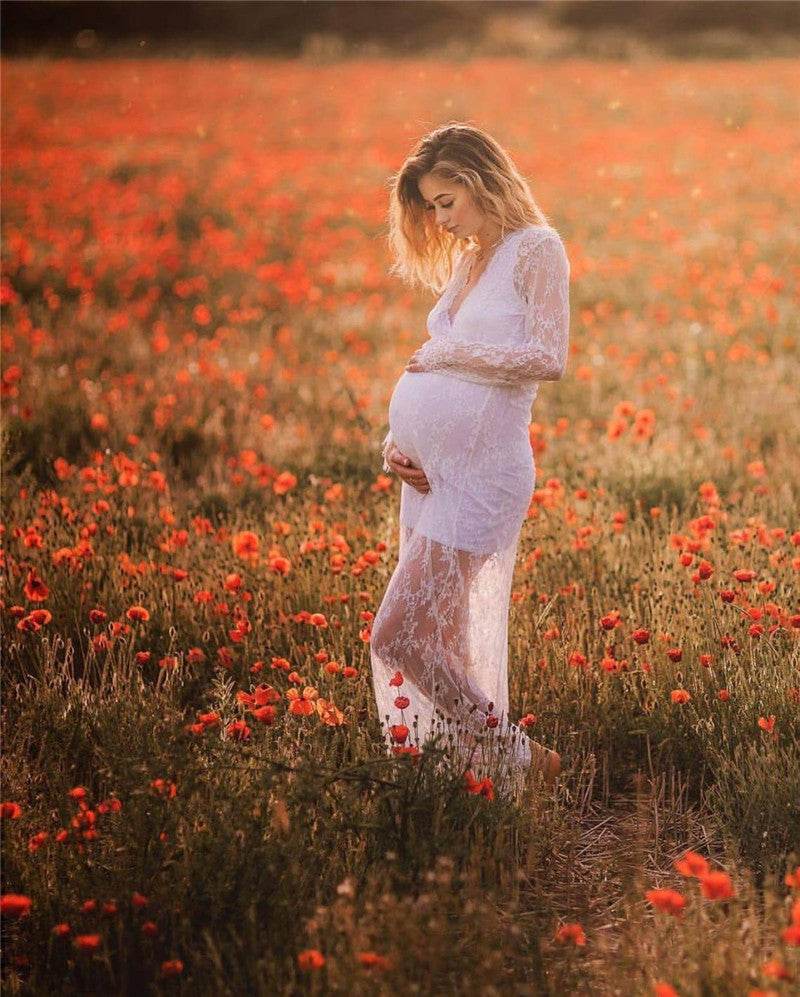 Maternity lace pattern long dress in a field of flowers, perfect for photoshoots.