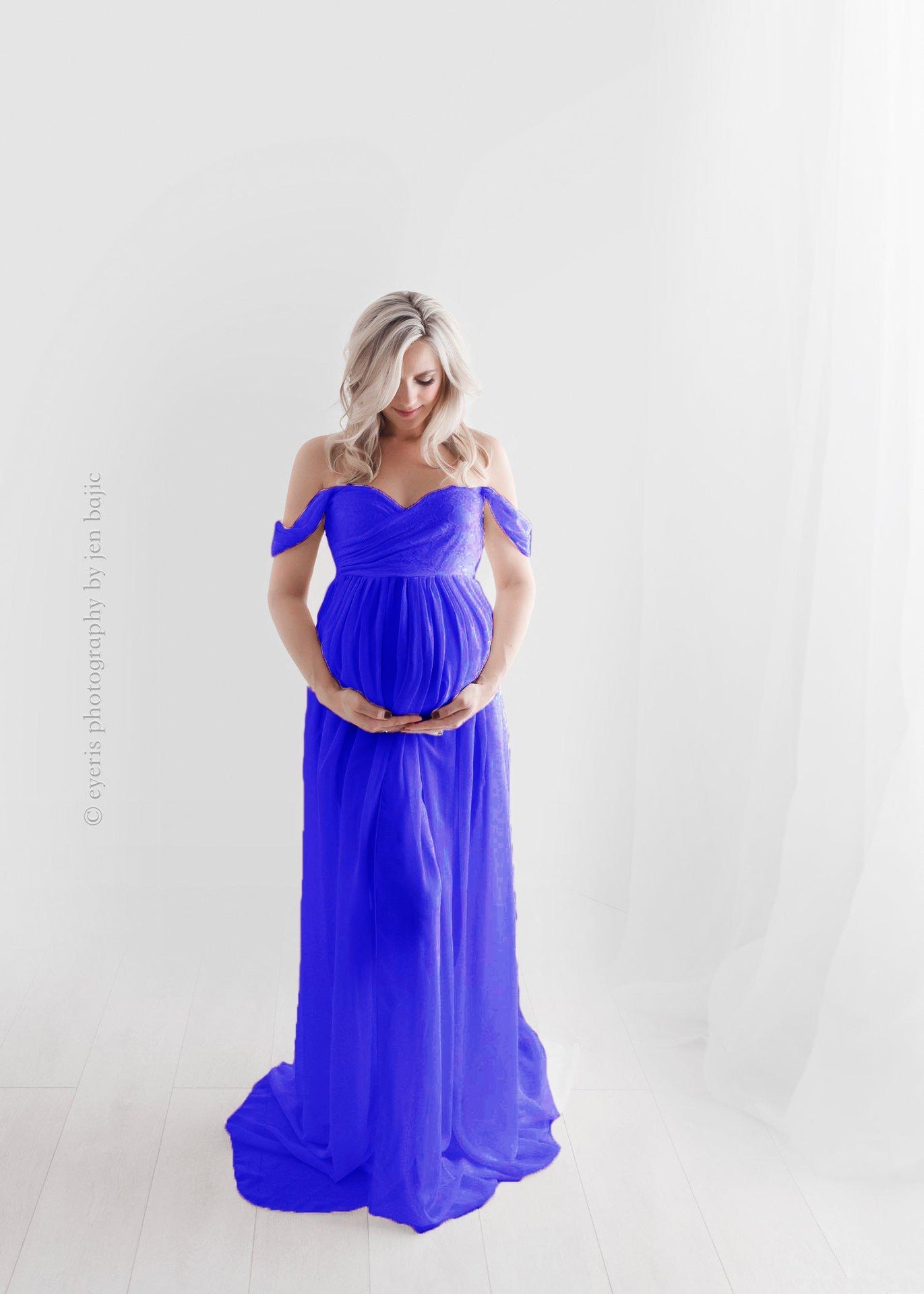 Maternity long mopping dress in royal blue showcasing an elegant flowing silhouette for photoshoots.