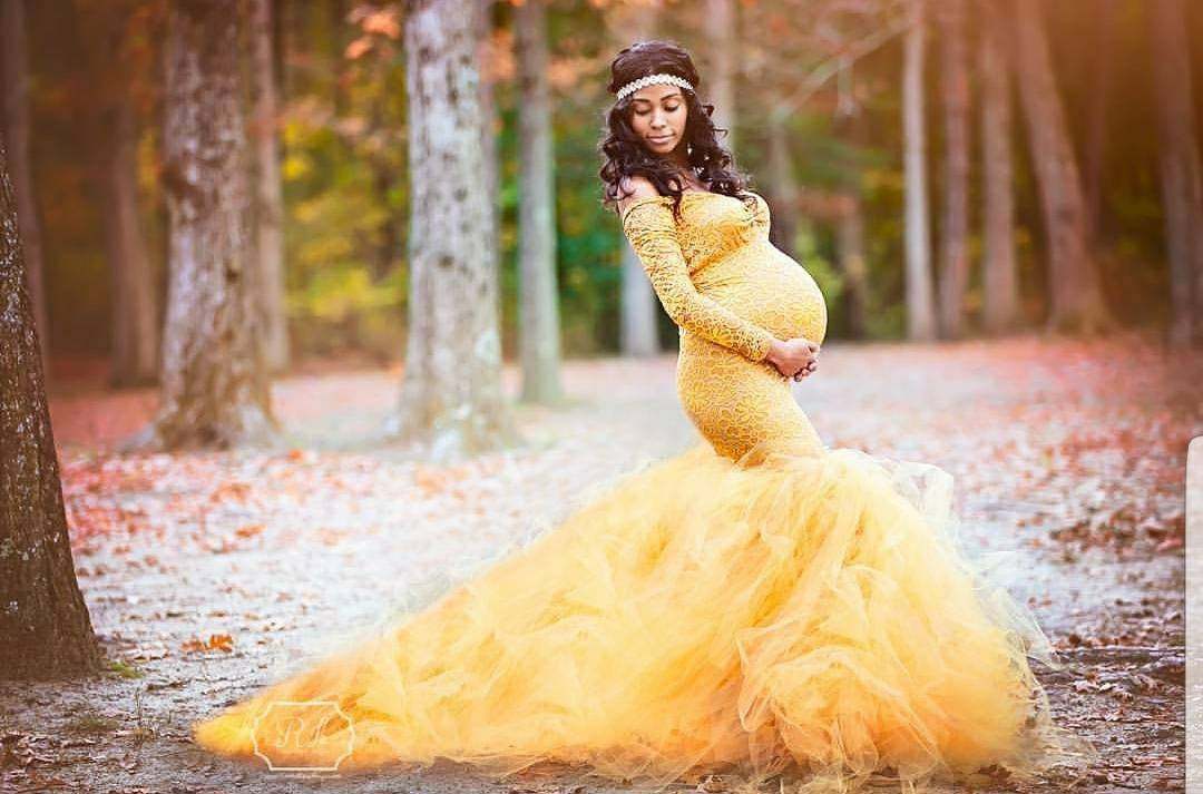 Maternity mesh lace dress with elegant tailing in a serene outdoor setting.