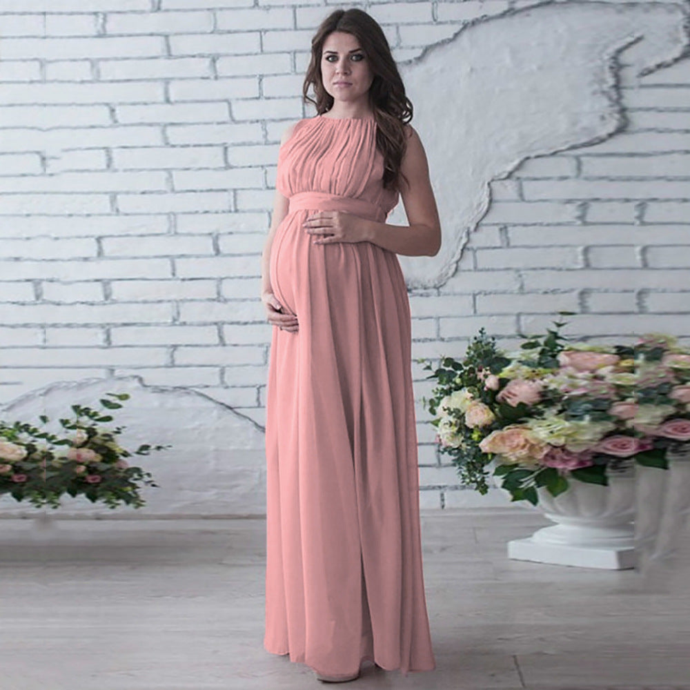 Elegant maternity maxi chiffon gown in soft pink, ideal for baby showers and special occasions.
