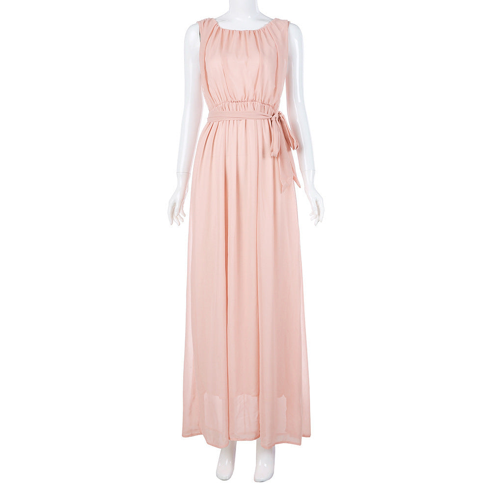 Elegant chiffon maternity maxi gown in blush color with a flowing silhouette and belt detail.